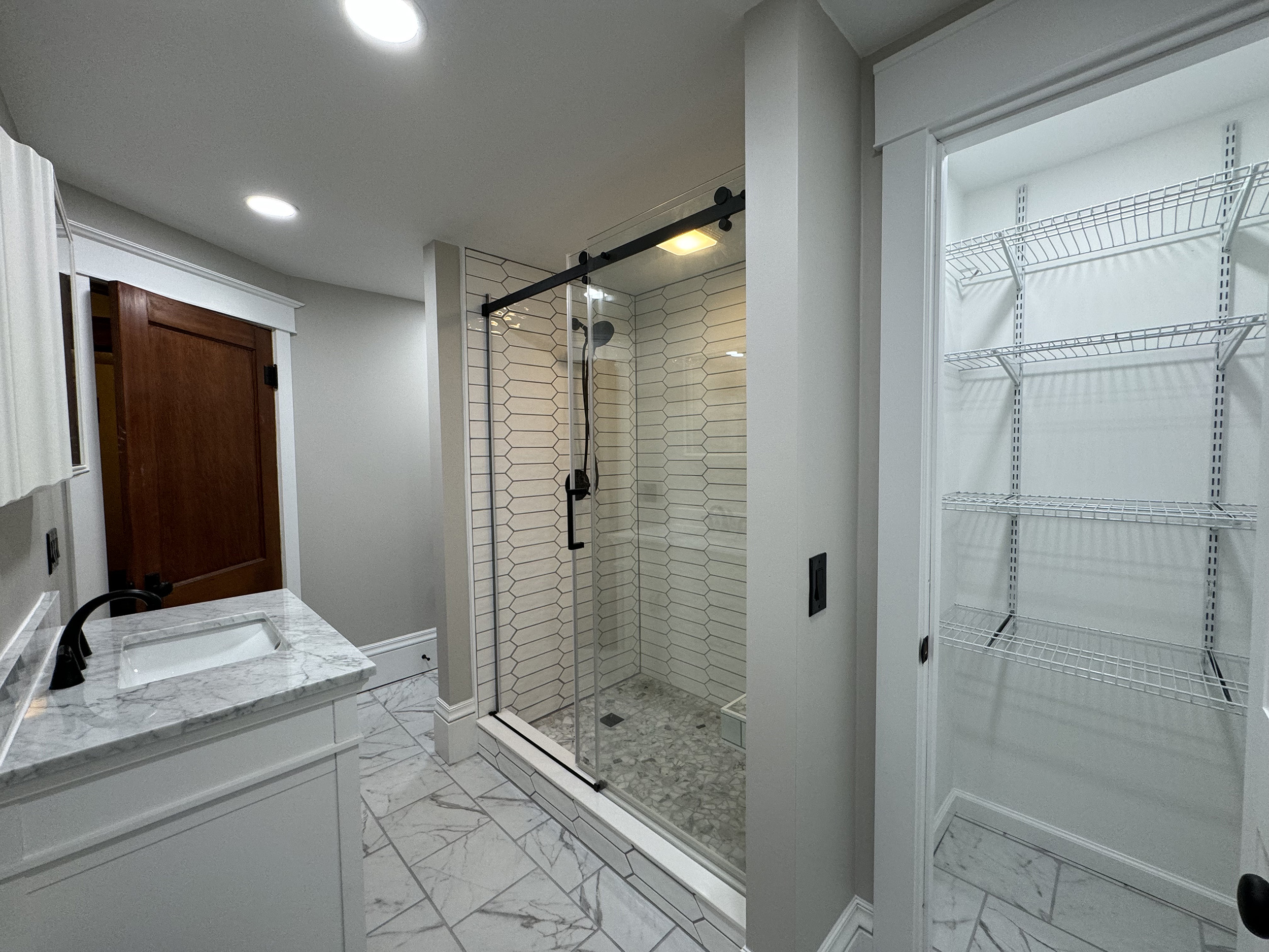 A bathroom remodel in Penn Yan, NY, vanity, shower and storage pictured.